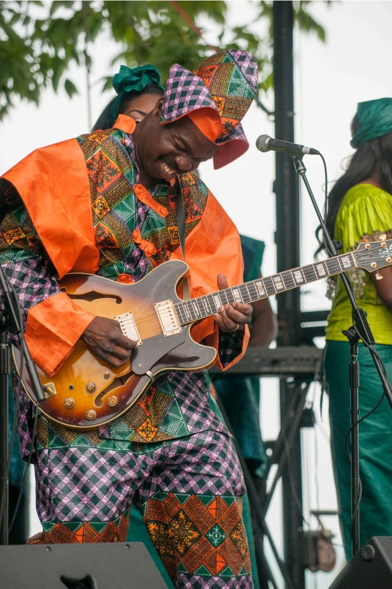 Toby Foyeh on stage with guitar — Evanston Arts